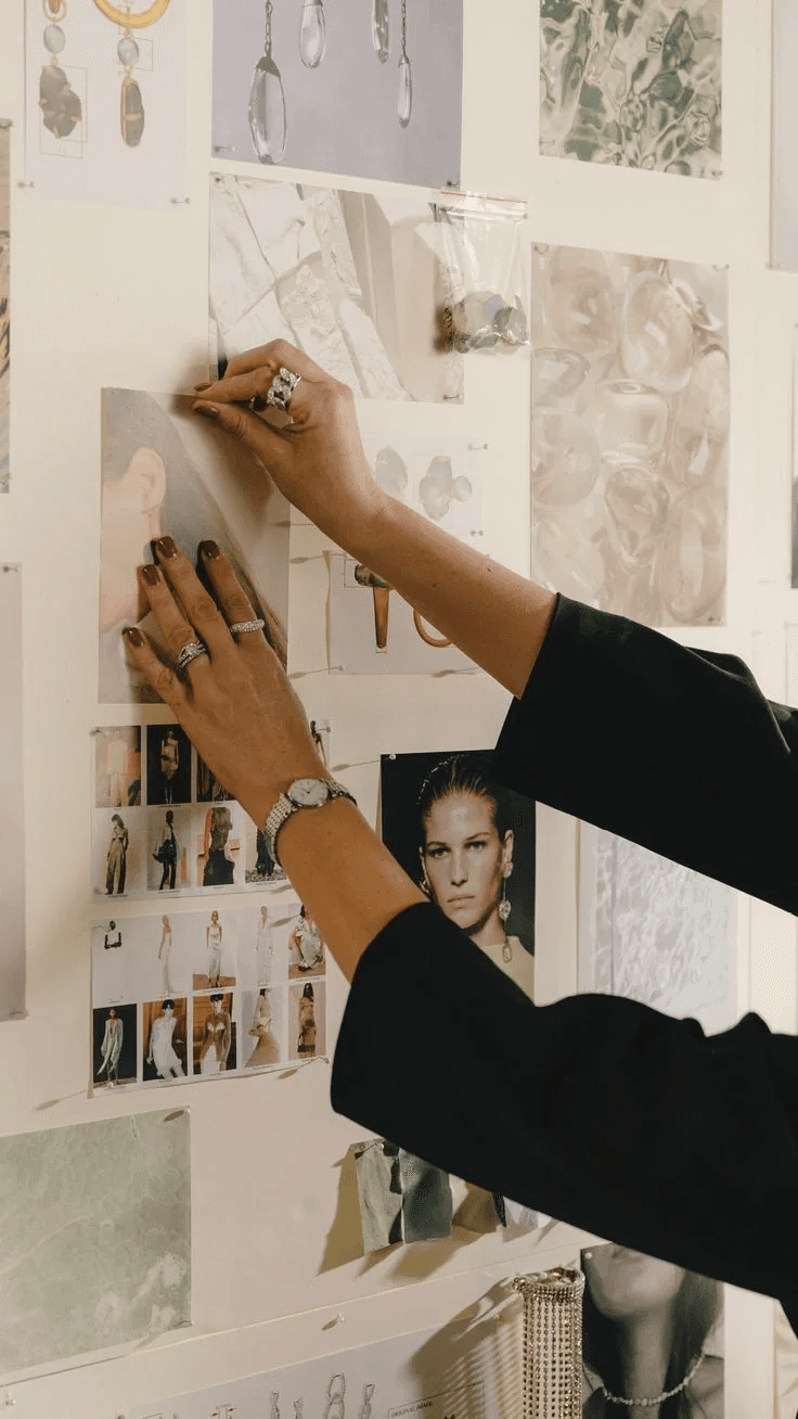 Hands developing a jewellery and fashion moodboard