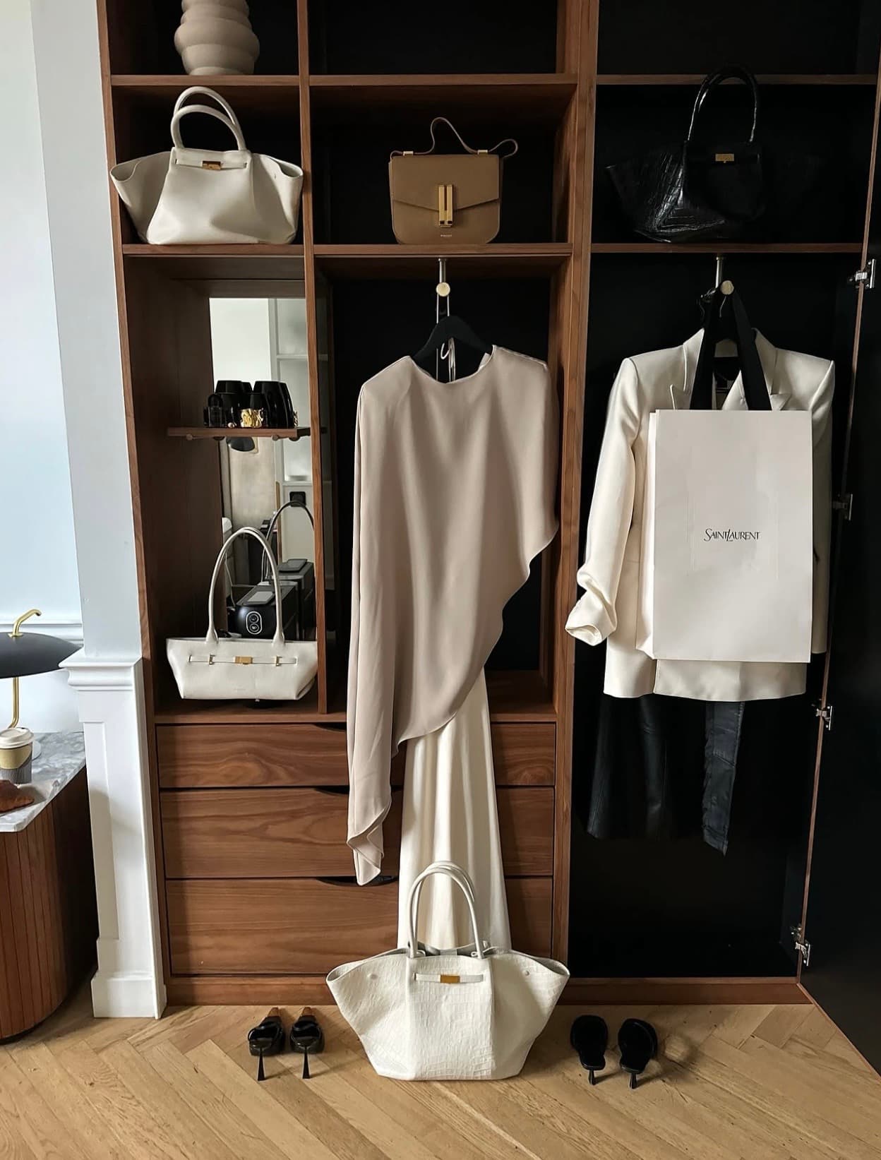 A tonal wardrobe edit with ivory garments and structured handbags