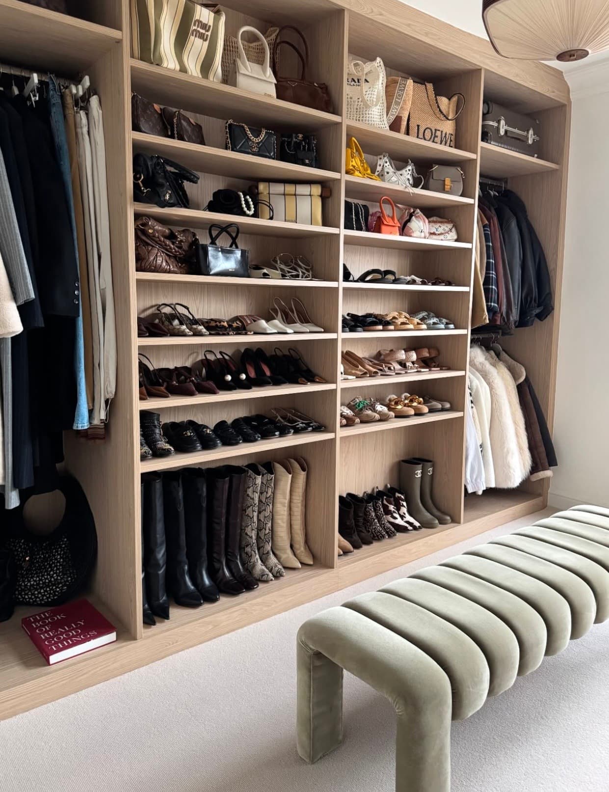 An open wardrobe organized across clothing, shoes, and handbags